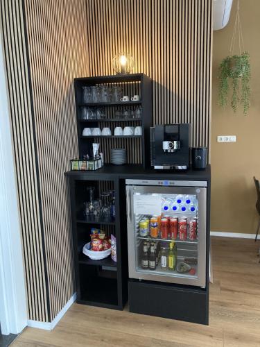 a small refrigerator with its door open in a room at B&B De Hofnar Roermond in Roermond