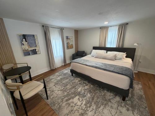 a bedroom with a large bed and a chair at Suite Safari in Tampa