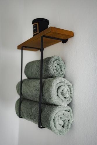 a pile of towels on a shelf on a wall at Apartman Barbara in Lipany