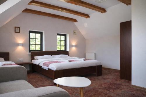 a bedroom with two beds and a couch at Stara Kuźnia Mazurska in Węgorzewo