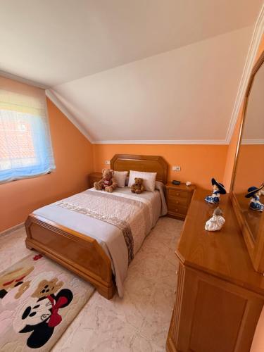 a bedroom with two teddy bears sitting on a bed at Chalet Bordones Playa in Bordons