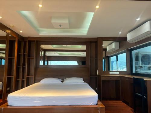a bedroom with a bed in a boat at PATONG TOWER APARTMENT's 2026 in Patong Beach