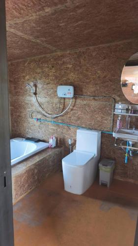 a bathroom with a sink and a toilet and a tub at บ้านสวนร่มไม้แอ๊ดเชียงดาว in Ban Hua Thung
