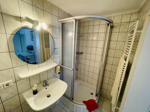 a bathroom with a shower and a sink and a mirror at Gasthaus Adler Weilheim, Waldshut in Weilheim