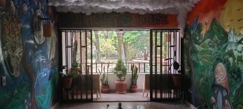 a room with a window with potted plants in it at Jungle house private room in Medellín