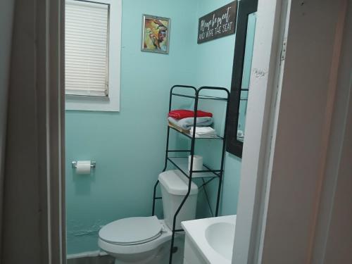 a bathroom with a toilet and a towel rack at GpL 4134 Cozy & Spacious 4BR Shared House in Fort Myers