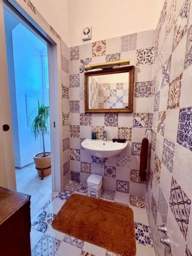 a bathroom with a sink and a mirror at VIlla Monte D'Alba in Trani