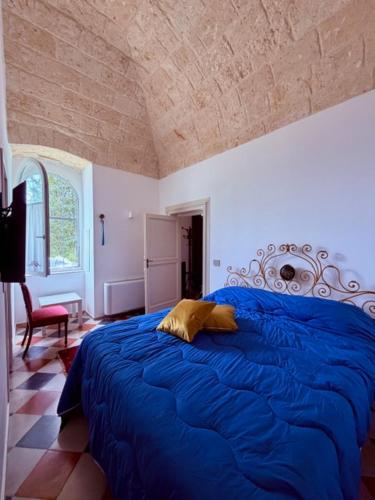 a bedroom with a large blue bed in a room at VIlla Monte D'Alba in Trani