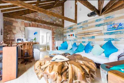 a large bedroom with a large bed with blue pillows at The Beach Barn in Cardiff