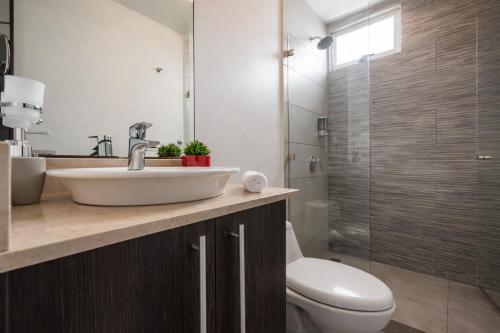 a bathroom with a sink and a toilet and a shower at Torre Ambar Executive Residences in San José