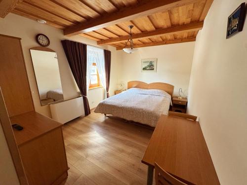 a bedroom with a bed and a wooden floor at Vila Banga in Nida