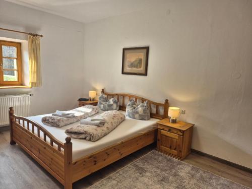 a bedroom with two beds and two lamps on tables at Gasthaus Staufenbrücke in Bad Reichenhall