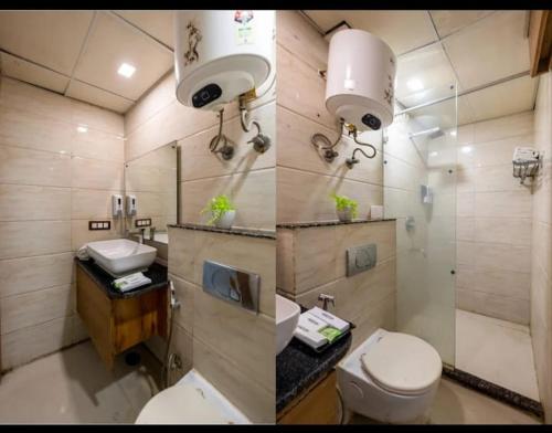 a bathroom with a toilet and a sink and a mirror at Hotel Lotus Paradise in Sonīpat