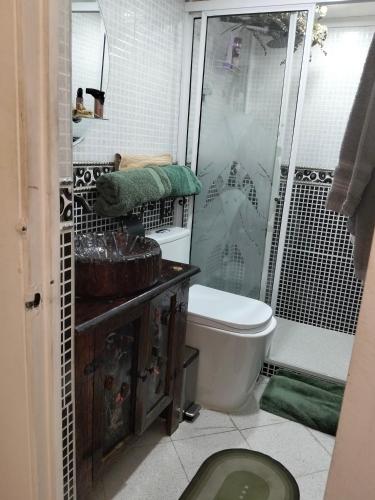 a bathroom with a shower and a toilet and a sink at Jungle House Medellin in Medellín