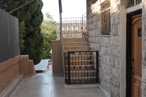 a set of stairs in a building with a gate at Tannous Aparthotel in Haifa