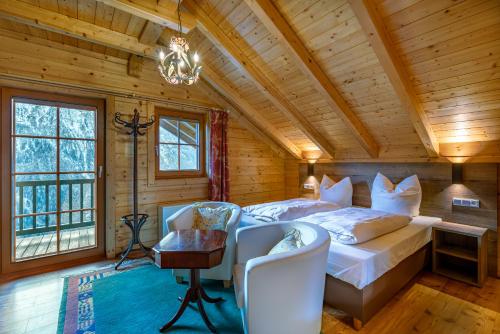 a bedroom with a bed and a chandelier at Haus Karin in Heiligenblut
