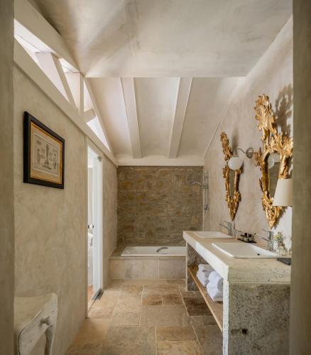 a bathroom with a large sink and a tub at Hotel Finca El Peregrino in Puente la Reina
