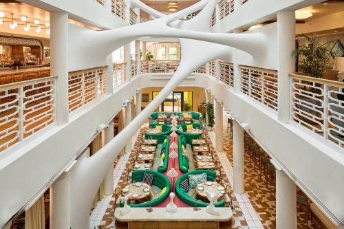 a view from the second floor of a library with tables at The Moore Miami in Miami