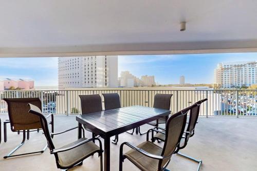 a table and chairs on a balcony with a view at TOPS'L Tides in Destin