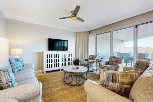 a living room with a couch and chairs and a tv at TOPS'L Tides in Destin