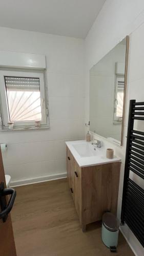 a white bathroom with a sink and a mirror at Las estrellas in Peniscola