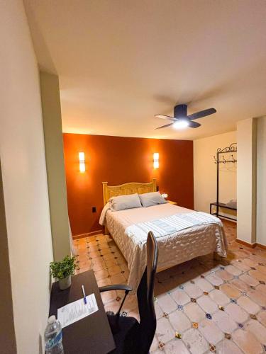a bedroom with a bed and a ceiling fan at La Estancia del Rey David in San Luis Potosí