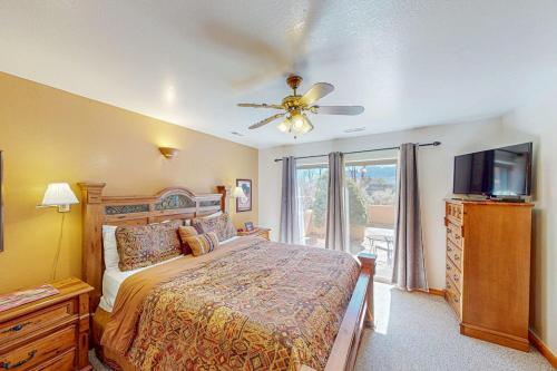 a bedroom with a bed and a ceiling fan at Castillo De Las Rocas 3418 in Moab