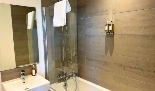 a bathroom with a shower and a sink at Findochty - 2 Bed Luxury Apartment by Together Travel in Wick