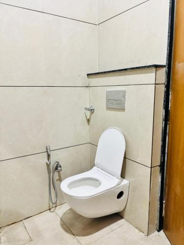 a bathroom with a toilet in a stall at Hotel Venus Stays Near Prestige College Bhopal in Bhopal