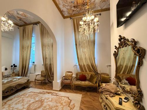 a room with a bed and a chandelier at Chateau D'Amour Luxury Boutique in Bucharest