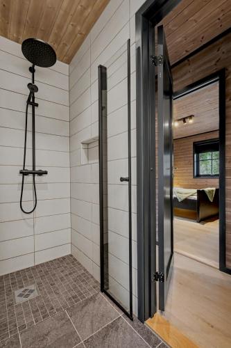 a room with a shower and a door to a bedroom at Stryn Mountain Lodge in Stryn