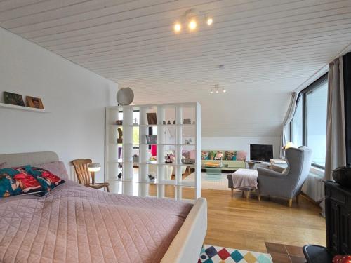 a bedroom with a bed and a living room at Fewo Lieblingsblick, gemütlich & chic in Bad Münstereifel