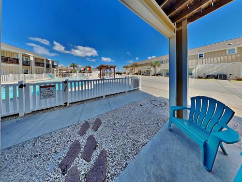 a blue bench sitting on the side of a street at Trestles in Padre Island
