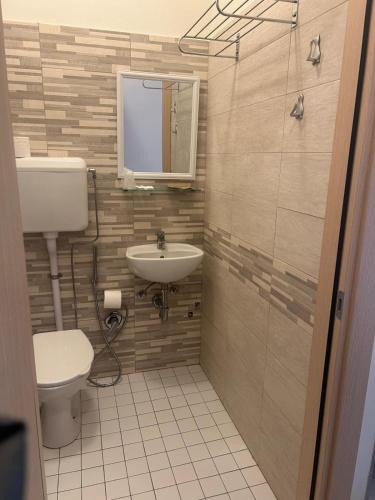 a bathroom with a toilet and a sink at Hotel Aron Rimini in Rimini