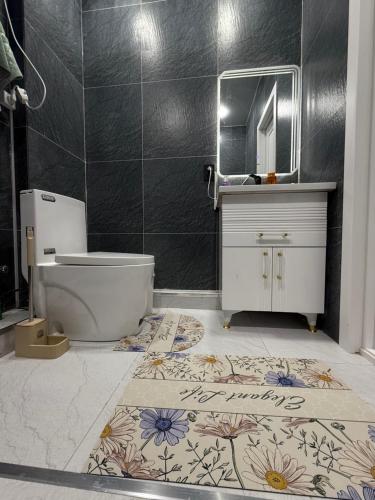 a bathroom with a toilet and a sink and a mirror at Silk Road Retreat City Center in Bukhara