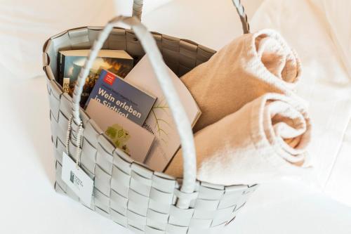 a basket filled with books and a book at Hotel Weingut Innerleiterhof in Schenna
