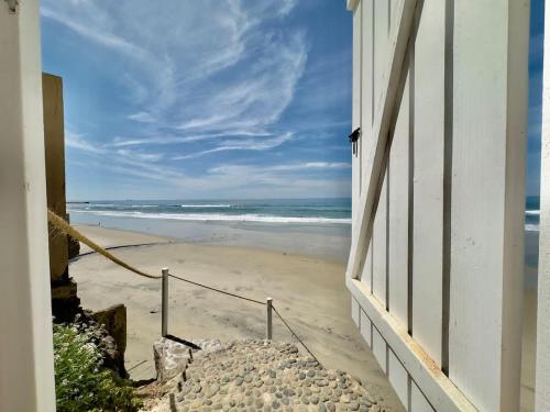 a view of the beach from the window of a house at San Antonio Del Mar - Beachfront Studio for Two in San Antonio del Mar