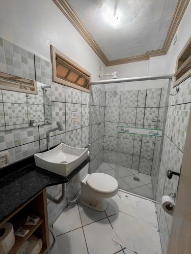 a bathroom with a toilet and a sink and a shower at Pousada do Mingote in Alter do Chao