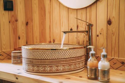a bathroom counter with a sink with at Antares Desert Camp in Merzouga
