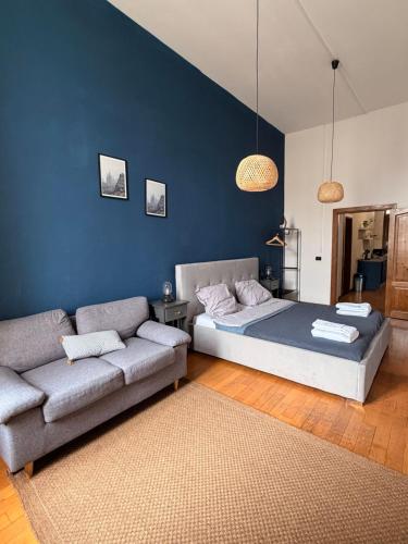 a bedroom with a bed and a couch at Blue Velvet Central Suite in Arad