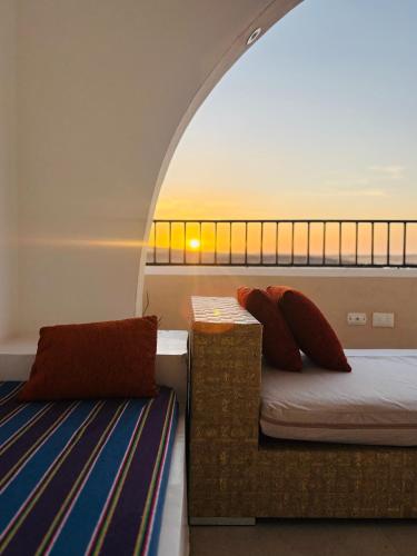 a bedroom with a bed and a couch in a room at Golden Sun House I in Abu Simbel