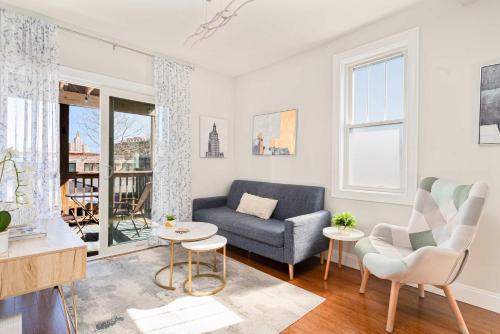 a living room with a blue couch and chairs at Jennifer's Getaway Stunning Views & Private Deck in Providence