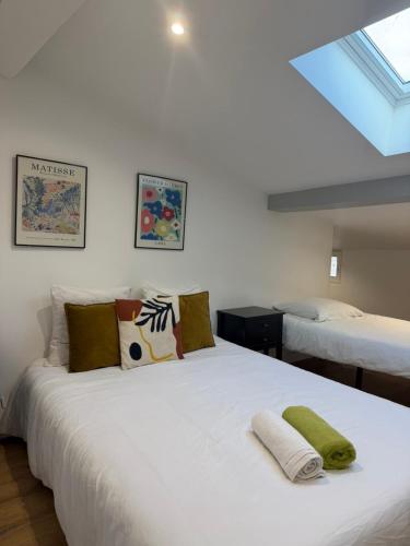 a bedroom with a large white bed with pillows at Bastille in Tournon-sur-Rhône