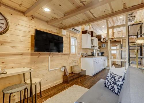 a log cabin living room with a flat screen tv at Red Rock Roost Posh Studio near Hiking Trails in Colorado Springs