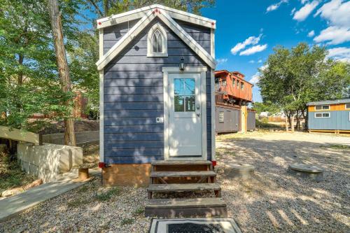 a tiny house with stairs leading to the door at Red Rock Roost Posh Studio near Hiking Trails in Colorado Springs