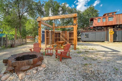 a playground with chairs and a fire pit and a train at Red Rock Roost Posh Studio near Hiking Trails in Colorado Springs