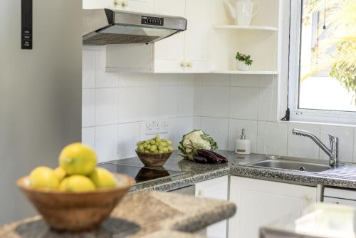a kitchen with a bowl of fruit on a counter at Villa Irina Polis in Polis Chrysochous