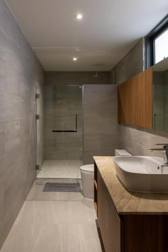 a bathroom with a sink and a toilet and a shower at Q Space Sathorn - Narathiwas 18 in Ban Nong Chaeng