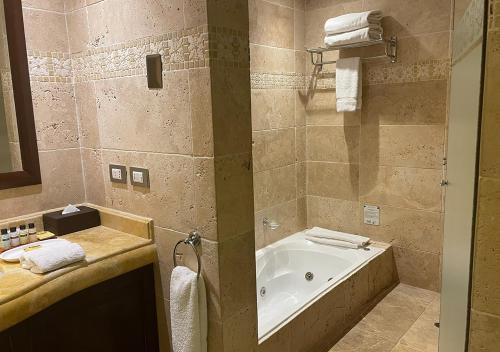 a bathroom with a bath tub and a sink at Aranwa Sacred Valley Hotel & Wellness in Urubamba