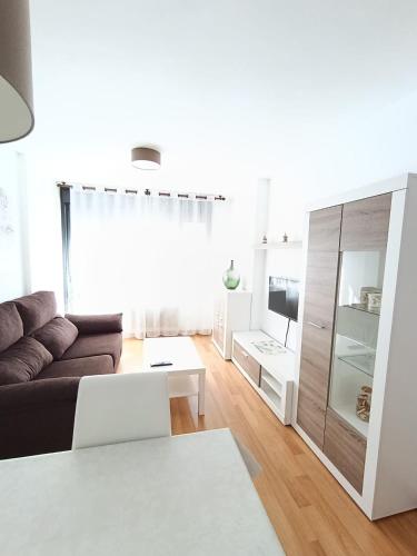 a living room with a couch and a table at La Escapada, muy cerca de Llanes in Llanes